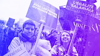 Women demonstrate with posters reading "Equal pay now" during a demonstration as part of the International Women's Day, Paris, 8 March 2023