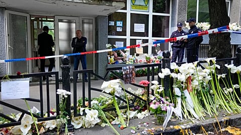 Police officers guard the Vladimir Ribnikar school in Belgrade following the shooting