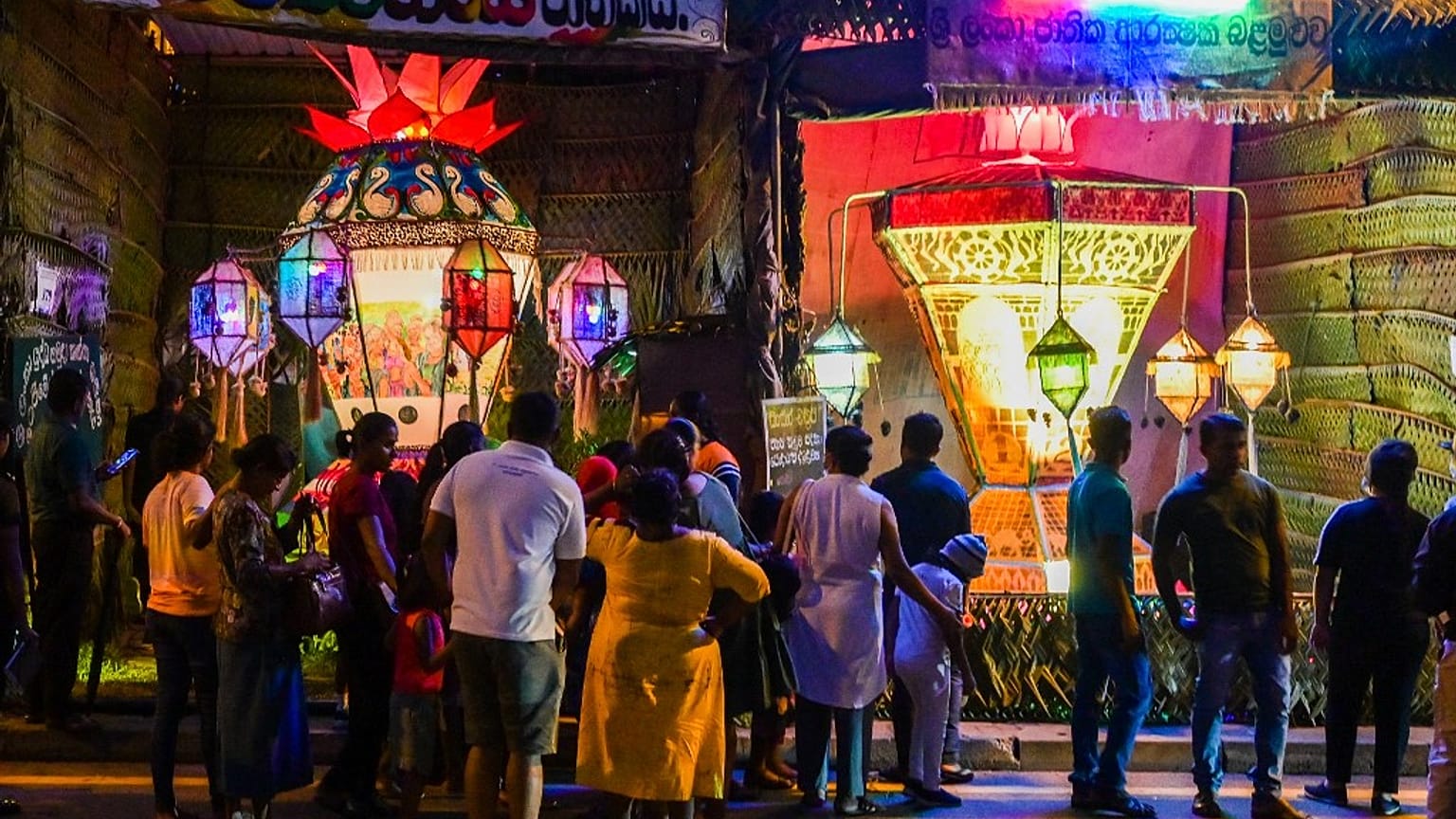 People watch lantern installations during 'Vesak festival', which commemorates the birth, the enlightenment and death of Buddha, in Colombo on May 6, 2023.