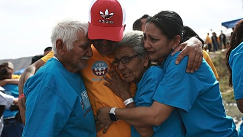 People living in the US embrace people their loved ones during the 10th annual "Hugs not Walls" event