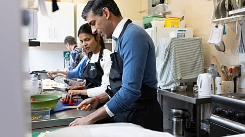 Britain's Prime Minister Rishi Sunak and his wife Akshata Murthy help prepare food as part of the Coronation Big Help Out, Rickmansworth, England, Monday May 8, 2023.