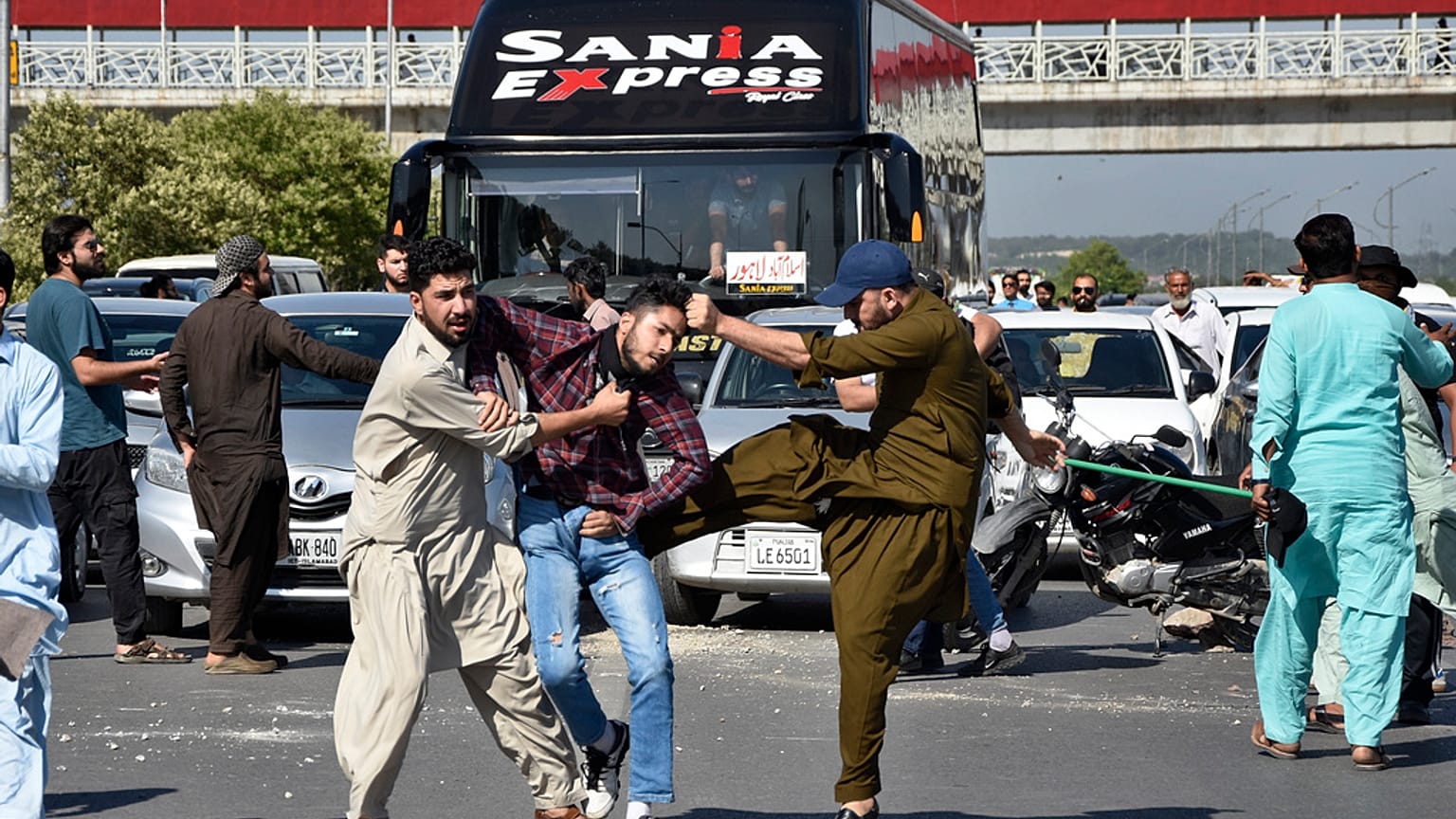 Plainclothes police officers beat a supporter of Pakistan's former Prime Minister Imran Khan as they detain him,  in Peshawar, Pakistan, Tuesday, May 9, 2023. 