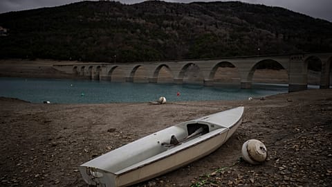A stranded boat is pictured above the water line at the lake Serre-Poncon in southern France, Tuesday, March 14, 2023.