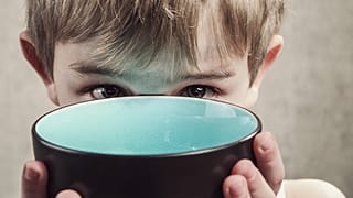 A child with an empty bowl,.