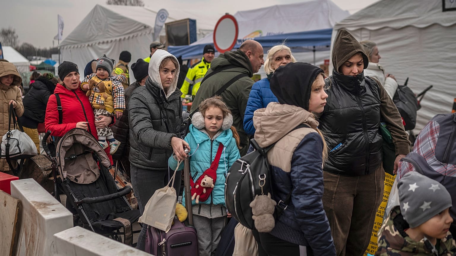 Ukrainian evacuees queue as they wait for further transport at the Medyka border crossing on March 29 2022