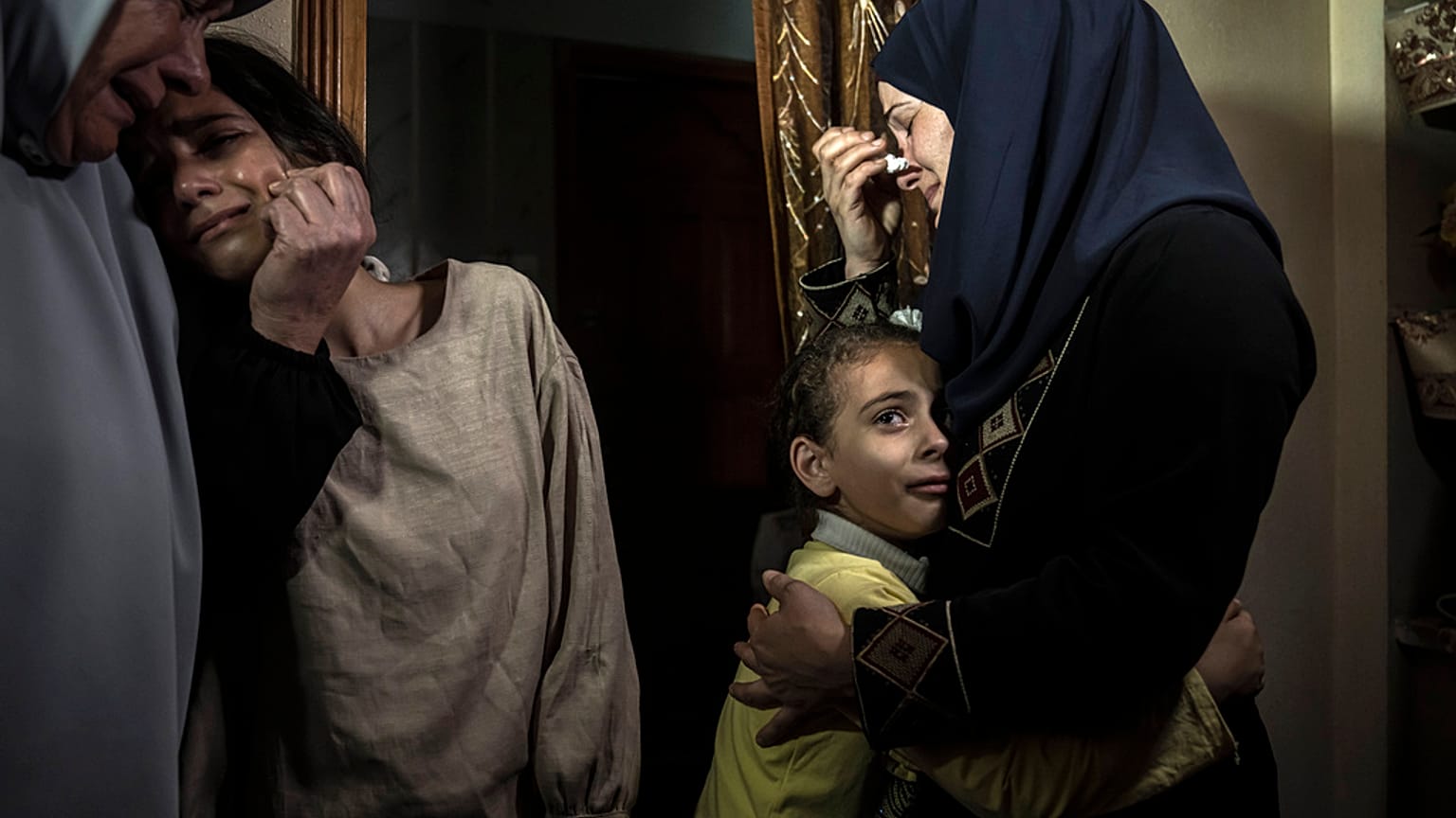 Palestinian relatives mourn for Islamic Jihad commander Ali Ghali and his brother, Mohammed Ghali, both killed in an Israeli airstrike on the Gaza strip, May 11, 2023.