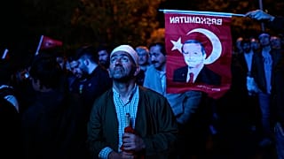 Supporters of Turkish President Recep Tayyip Erdogan watch news on a giant screen outside AKP (Justice and Development Party) office Istanbul, Turkey, Sunday, May 14, 2023