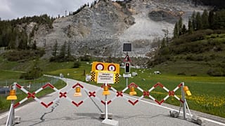 A road is blocked in front of the "Brienzer Rutsch" rockfall danger zone in Brienz-Brinzauls, Switzerland, Friday, May 12, 2023.