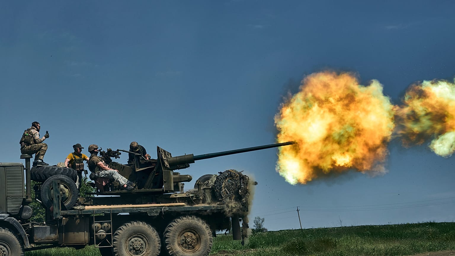 Ukrainian soldiers fire a cannon near Bakhmut, an eastern city where fierce battles against Russian forces have been taking place, in the Donetsk region, Ukraine, Monday, May 