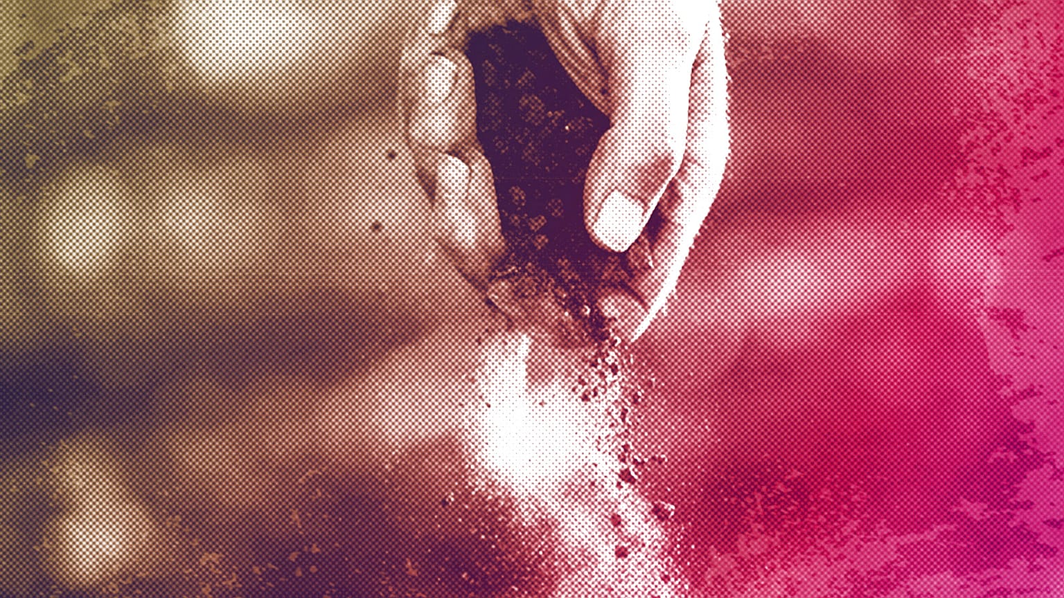 A farmer drops dusty soil from a cotton crop he shredded and planted over with wheat, October 2022