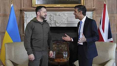UK PM Rishi Sunak and Ukraine's President Zelenskyy, walk in the garden at Chequers, the premier's official country residence, in Aylesbury, England, Monday, May 15, 2023.