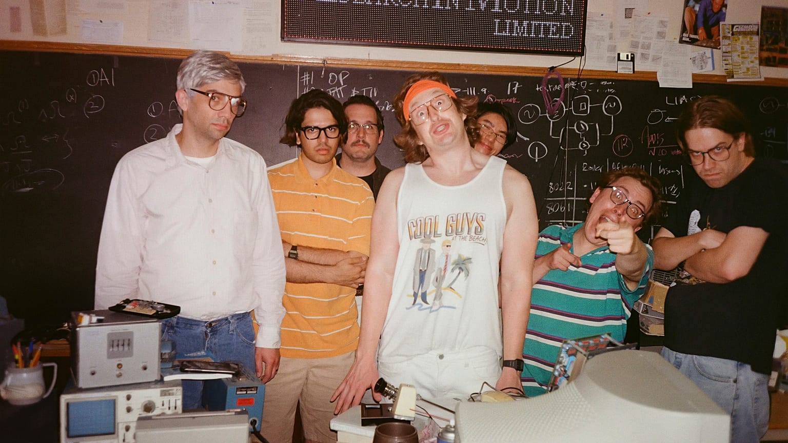 This image released by IFC Films shows Jay Baruchel, left, and actor-director Matt Johnson, center, with cast members on the set of "BlackBerry."
