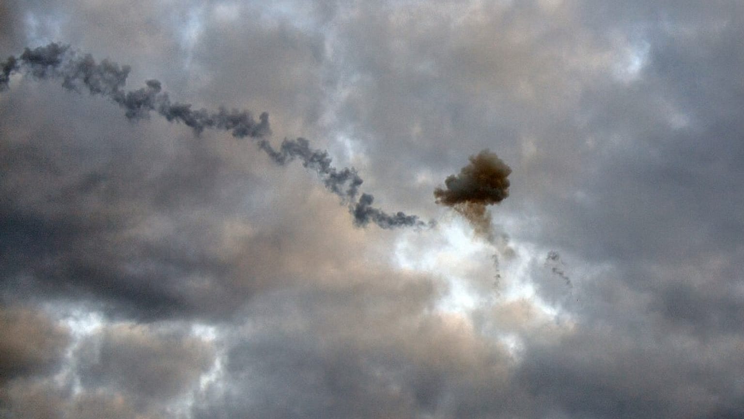 This picture taken early morning on May 9, 2023, in Kyiv, shows a smog of explosion after Ukrainian air defence downed missile.