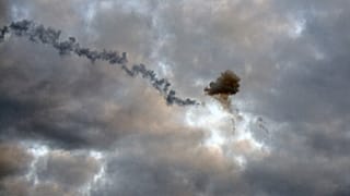 This picture taken early morning on May 9, 2023, in Kyiv, shows a smog of explosion after Ukrainian air defence downed missile.