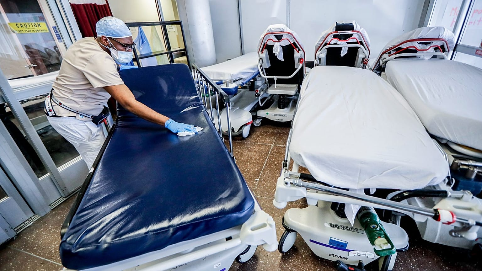 A medical worker cleans gurneys in the emergency department intake area at NYC Health + Hospitals Metropolitan in New York, May 27, 2020. 