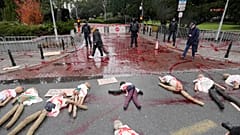Dummies covered in red paint were placed on a street in Poland to signify women suffering due to abortion restrictions during a protest in Warsaw. 30 November 2021