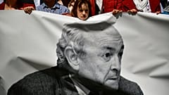 A young girl saves a silence minute in honor of Tomas Caballero, his portrait on the banner, a regional politician of the City Hall killed by ETA.