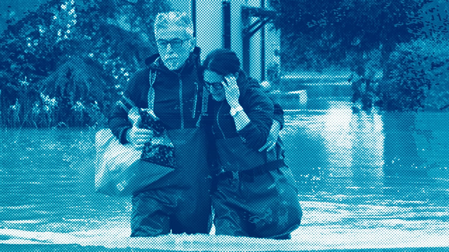 A couple walk in a flooded road of Lugo, Italy, 18 May 2023