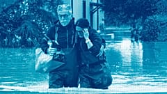 A couple walk in a flooded road of Lugo, Italy, 18 May 2023