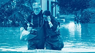 A couple walk in a flooded road of Lugo, Italy, 18 May 2023