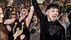 Rapper Kaarija of Finland (R) greets his supporters after arriving from the Eurovision Song Contest 2023