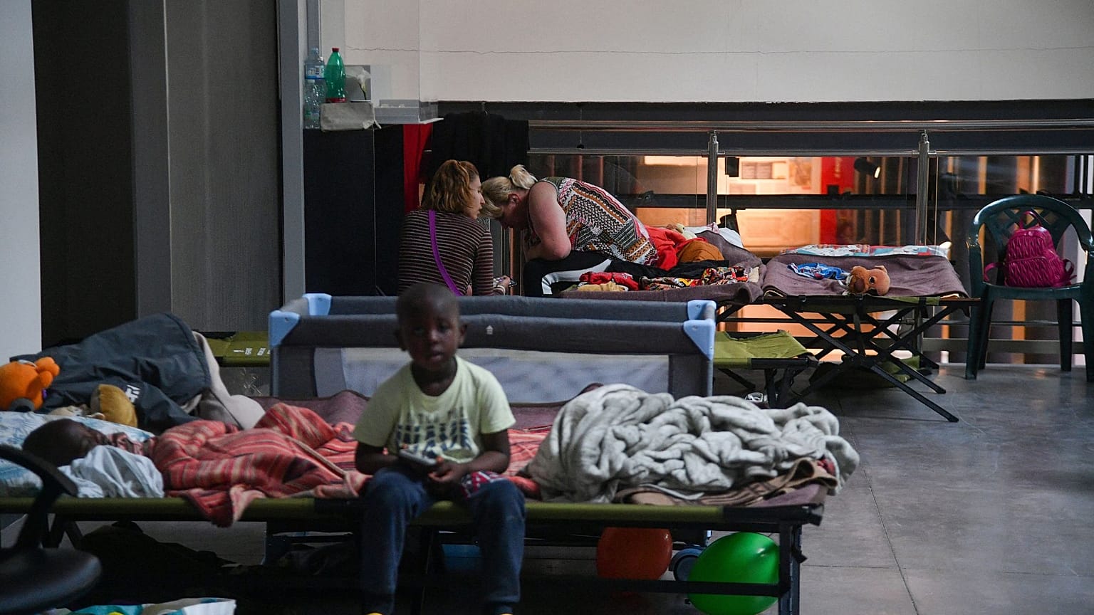 Displaced people prepare to spend the night in a dormitory set up on May 18, 2023 in the Classis museum of Ravenna.