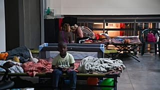 Displaced people prepare to spend the night in a dormitory set up on May 18, 2023 in the Classis museum of Ravenna.