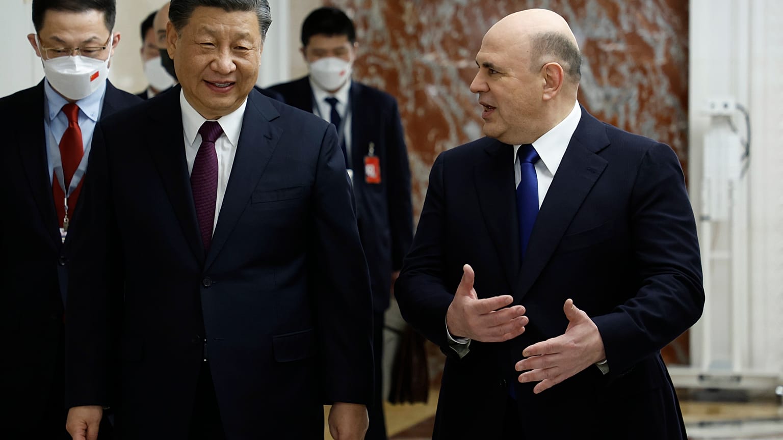 Russian Prime Minister Mikhail Mishustin, right, gestures as he speaks to Chinese President Xi Jinping during their meeting in Moscow, Russia, Tuesday, March 21, 2023.