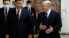 Russian Prime Minister Mikhail Mishustin, right, gestures as he speaks to Chinese President Xi Jinping during their meeting in Moscow, Russia, Tuesday, March 21, 2023.