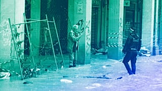 A man talks with a city police officer on a flooded street in Bologna, 17 May 2023