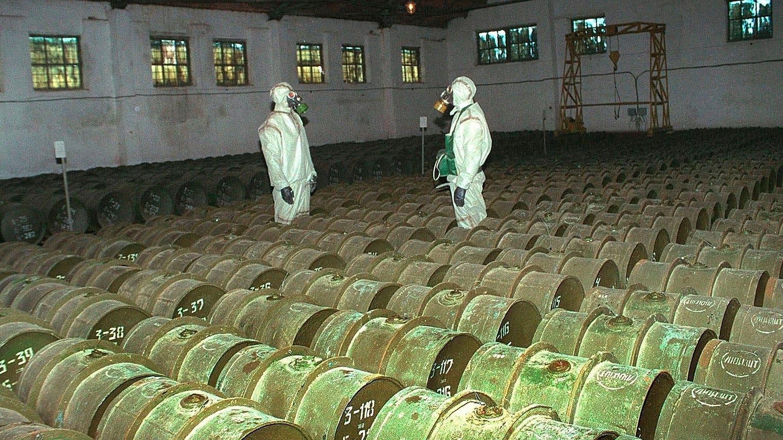 FILE - In this Saturday, May 20, 2000 file photo, two Russian soldiers make a routine check of metal containers with toxic agents at a chemical weapons storage site.