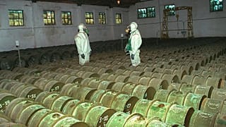 FILE - In this Saturday, May 20, 2000 file photo, two Russian soldiers make a routine check of metal containers with toxic agents at a chemical weapons storage site.