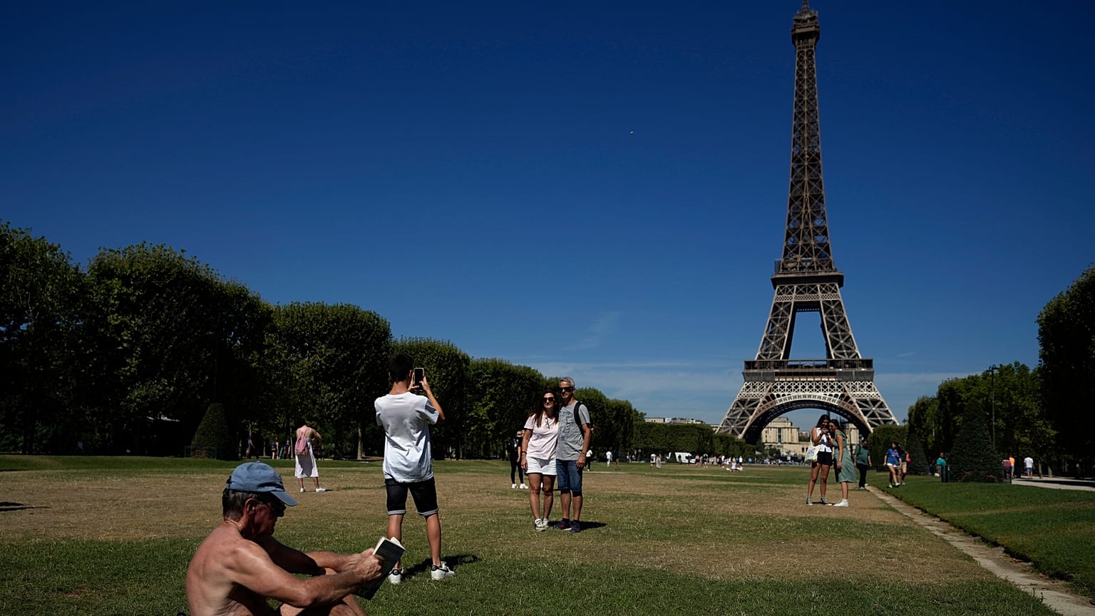 Tourists sunbathe, as Europe is under an unusually extreme heat wave, in Paris, France in 2022.