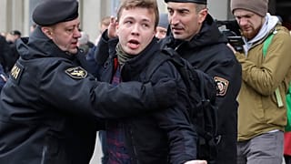 Belarus police arrest journalist Raman Pratasevich, center, in Minsk, Belarus.