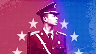A Chinese paramilitary policeman stands on duty in front of the European flag outside the office of the EU delegation to China in Beijing, October 2011