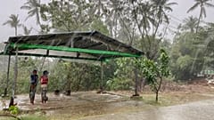 Two children stand under a roadside shelter to protect from rain before Cyclone Mocha hits in Sittwe, Rakhine State.