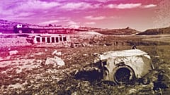 An old rusty washing machine is seen on the dry bed of the Entrepenas reservoir near Madrid, August 2006