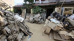 Household goods are piled outside a building after heavy flooding, in Faenza, Italy, Monday, May 22, 2023