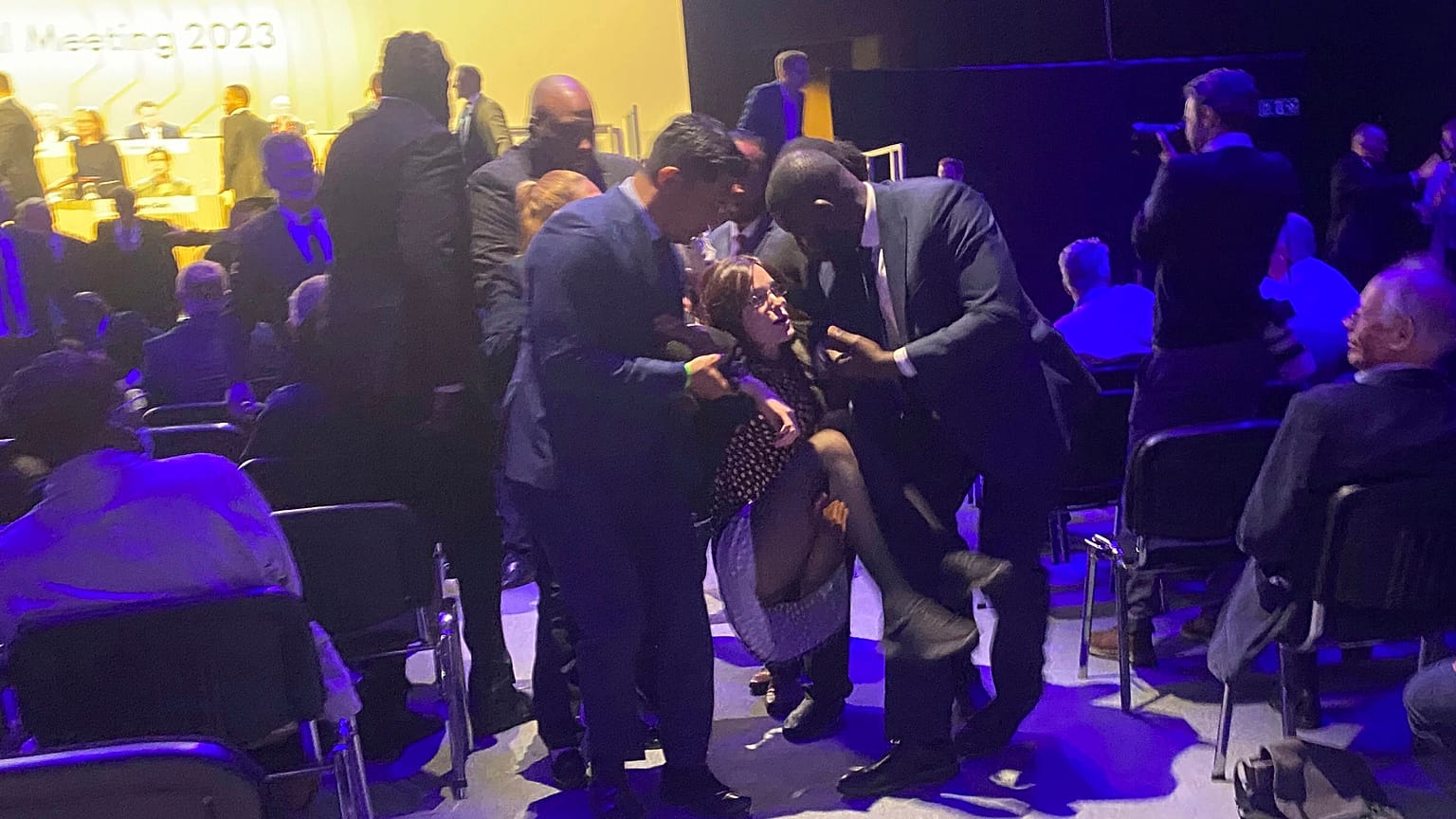 Protesters who tried to storm the stage are taken out of the Excel centre in east London during oil giant Shell's annual general meeting in London, Tuesday, May 23, 2023
