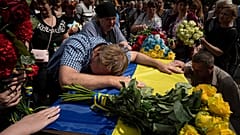 Parents cry over the coffin of their son Andrii Konyaev, a member of the Azov regiment defending Mariupol.