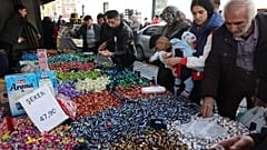 Shoppers browse candy and sweets at a market stall in the historical Ulus district of Ankara, on April 19, 2023.