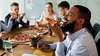 Is this the end of office pizza parties? Companies are cutting costs and work perks are on the chopping block.