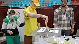 A voter casts his ballot for the second round of Turkey's presidential election at a polling station in Nicosia