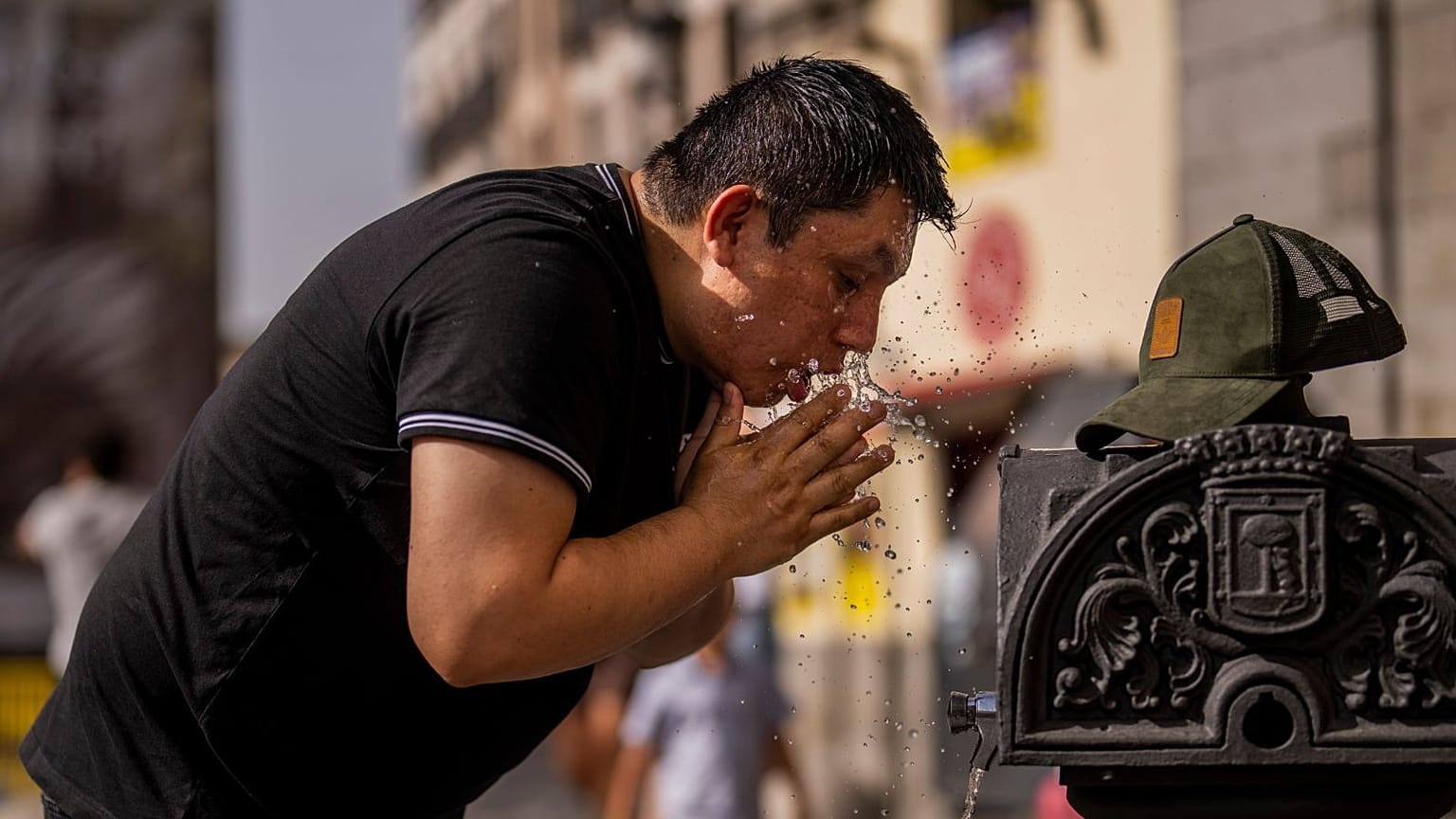 A man cools off in a fountain during a heatwave in Madrid. Is climate change finally becoming a major election issue in Spain? 