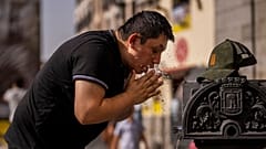 A man cools off in a fountain during a heatwave in Madrid. Is climate change finally becoming a major election issue in Spain? 