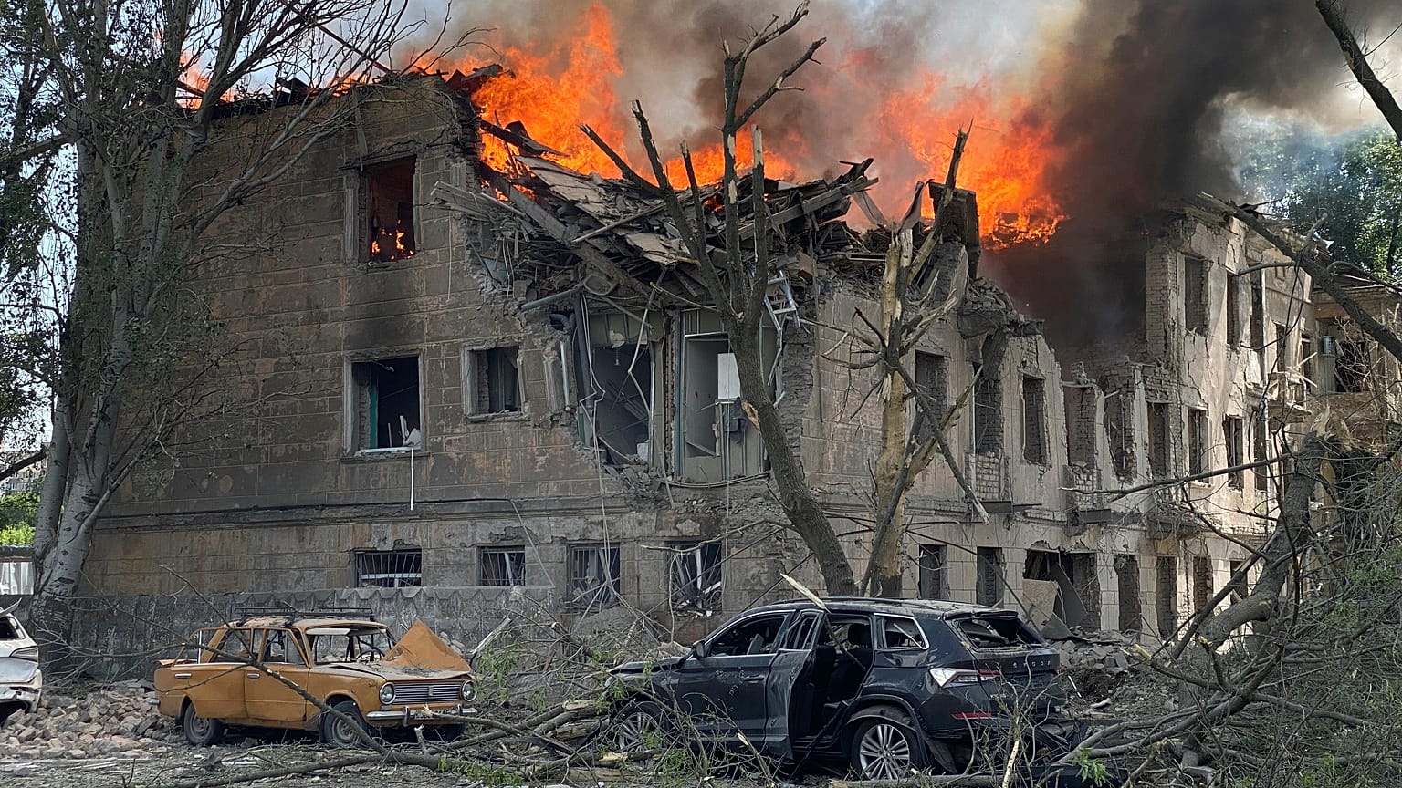 Firefighters hose down a Policlinic following a Russian attack in Dnipro, Ukraine,