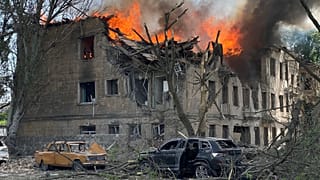 Firefighters hose down a Policlinic following a Russian attack in Dnipro, Ukraine,