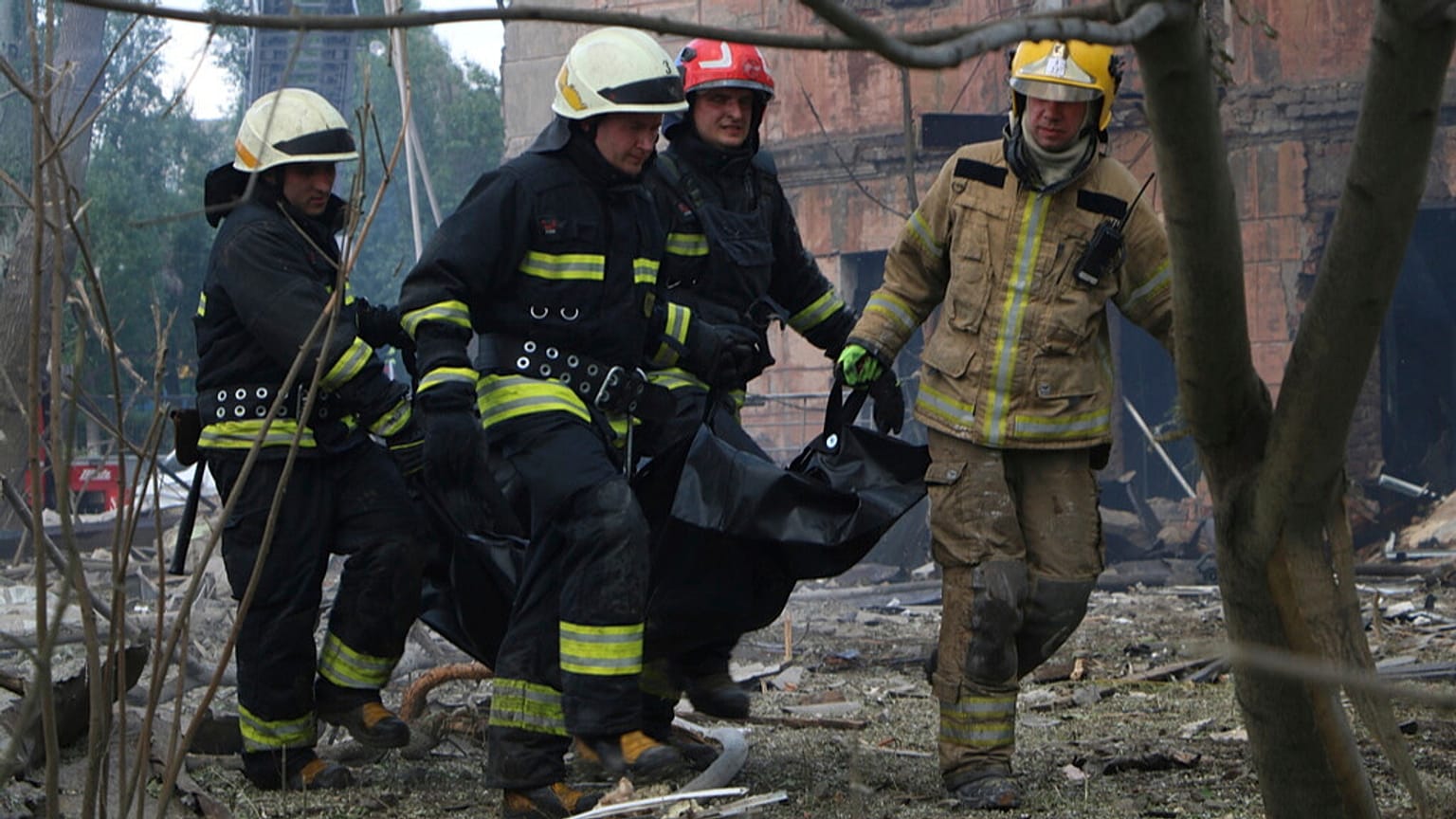 Firefighters carry a body after a Russian attack in Dnipro, Ukraine