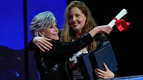 Justine Triet, right, accepts the Palme d'Or for 'Anatomy of a Fall,' which was presented by Jane Fonda, left, during the awards ceremony of the 76th film festival.