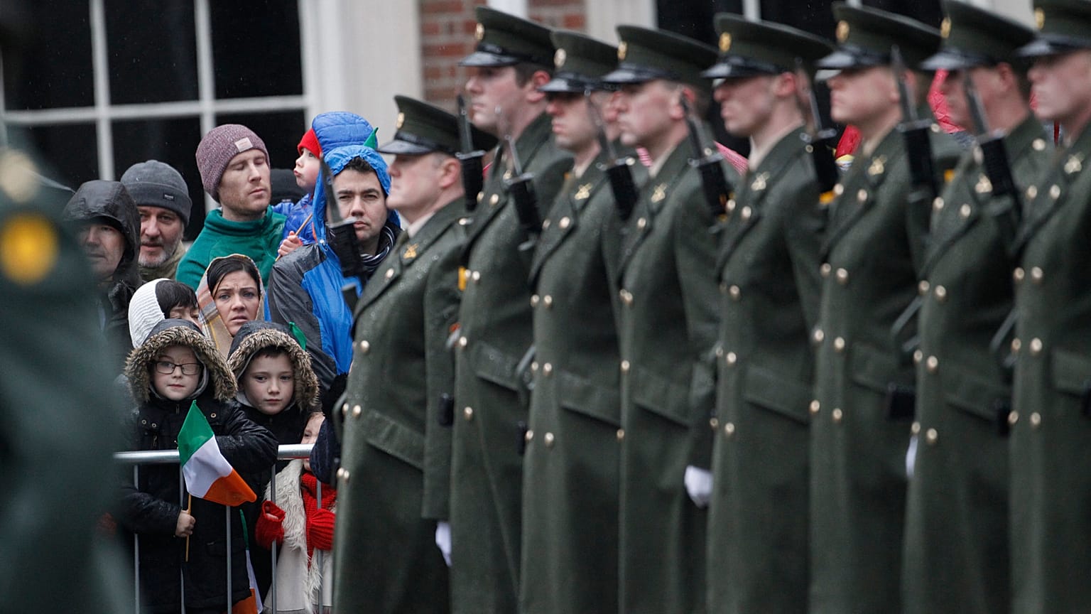Members of the public wait for the President of Ireland Michael D. Higgins to inspect the Irish defense forces guard of honour at Dublin Castle, Ireland, Friday Jan. 1, 2016.